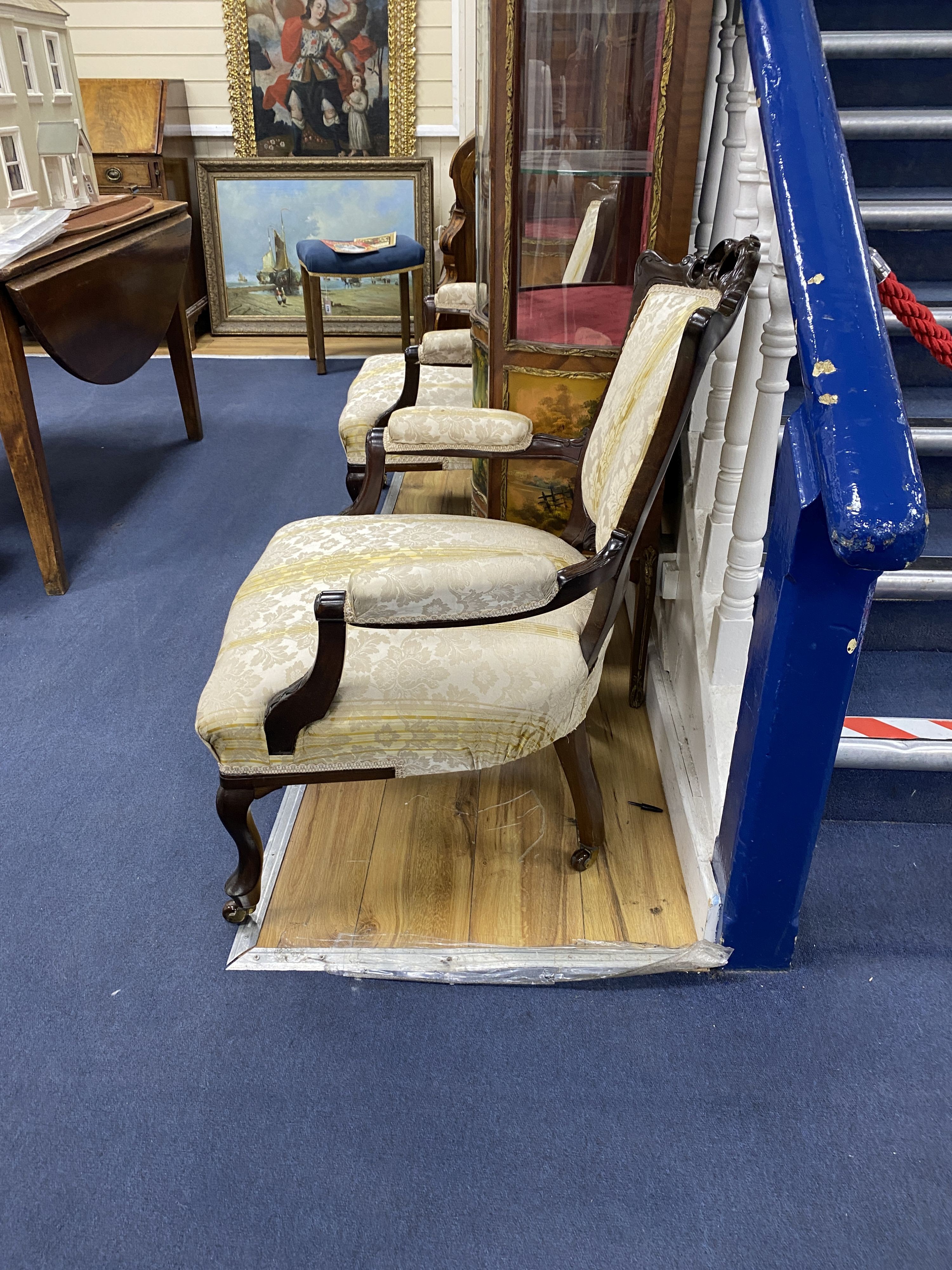 A pair of late Victorian carved mahogany open armchairs, width 66cm, depth 70cm, height 76cm